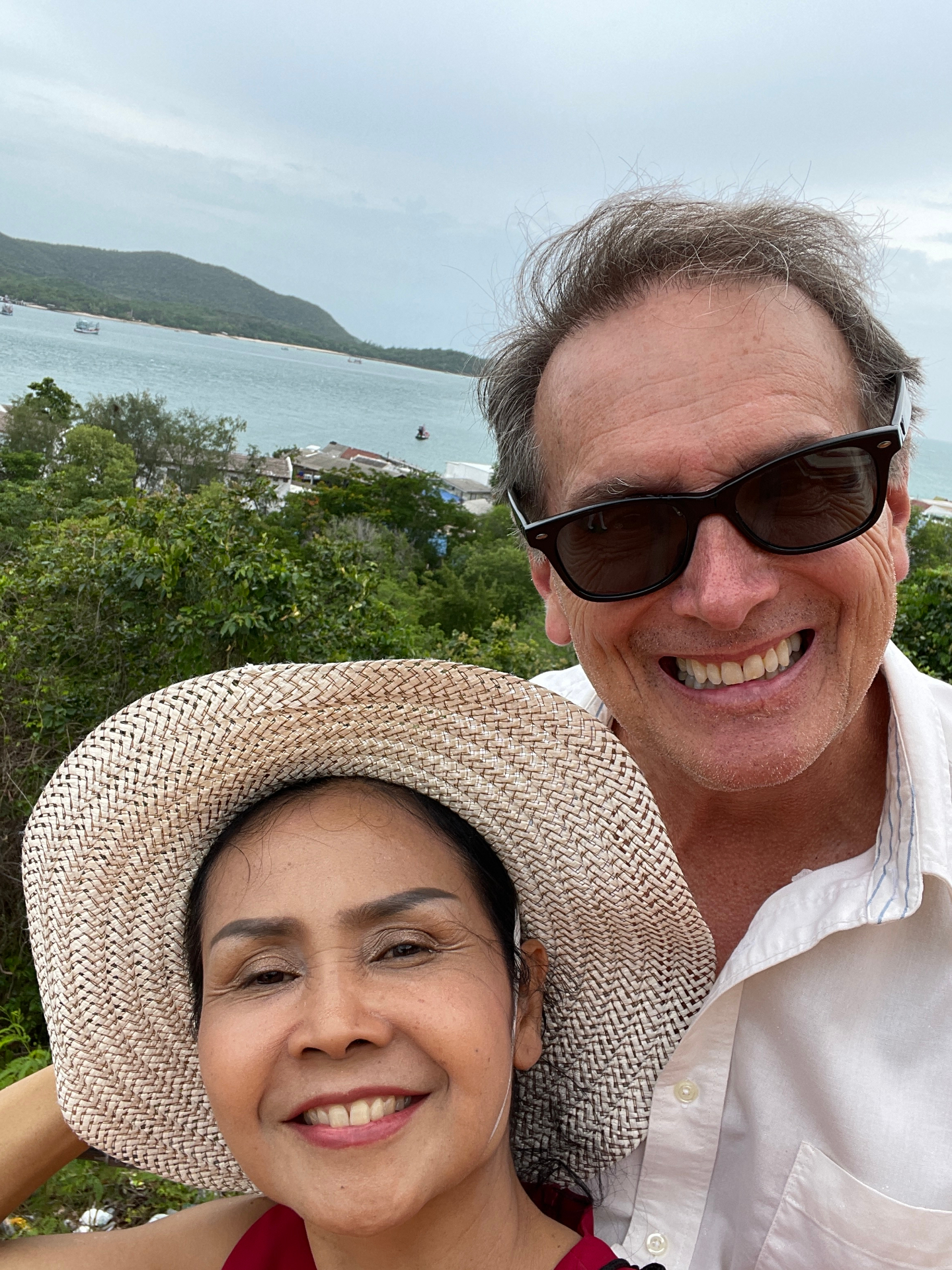Ethan and Pranisa on a hilltop overlooking the sea