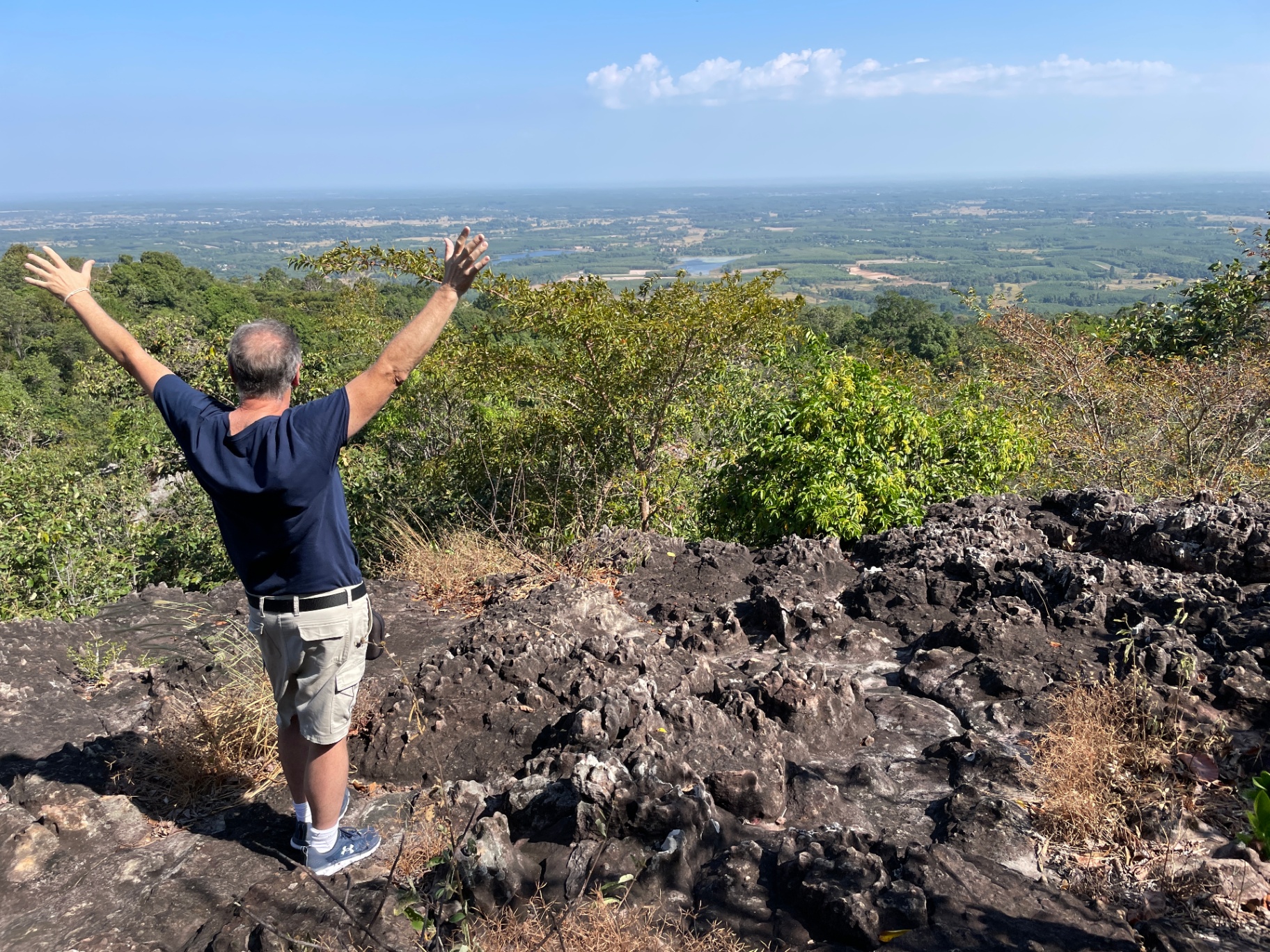 Ethan celebrating at a hilltop overlook in Thailand