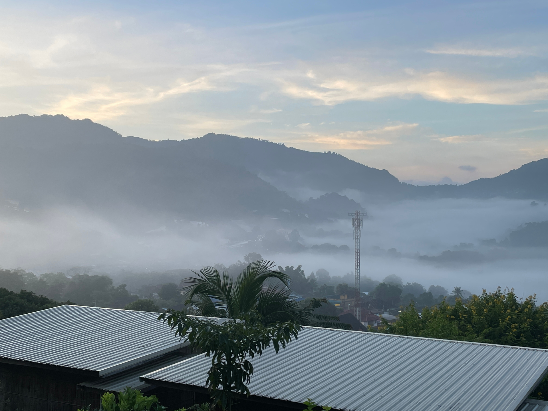 Fog rolling through the mountain valley at sunrise in northern Thailand